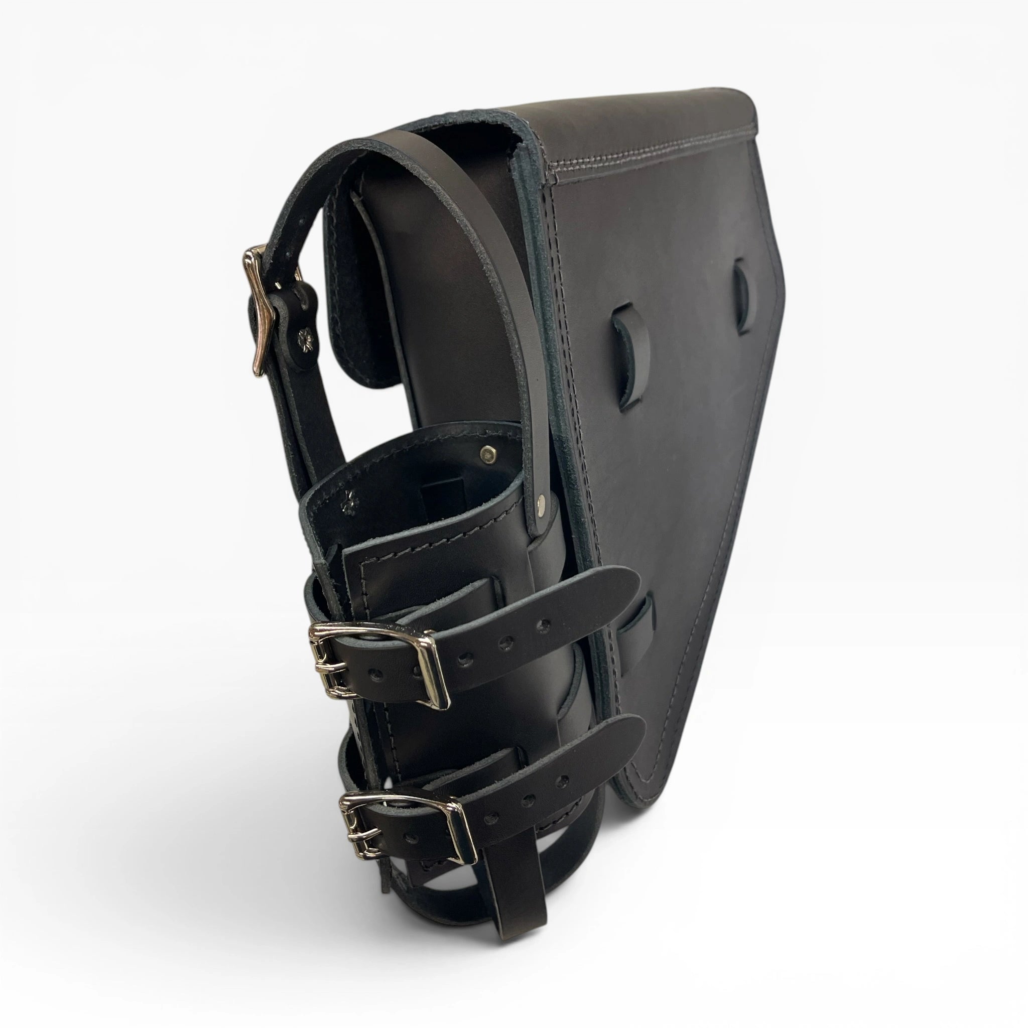 A black leather motorcycle leg shield with adjustable straps and silver-tone buckles, shown from a three-quarters angle on a light gray background.