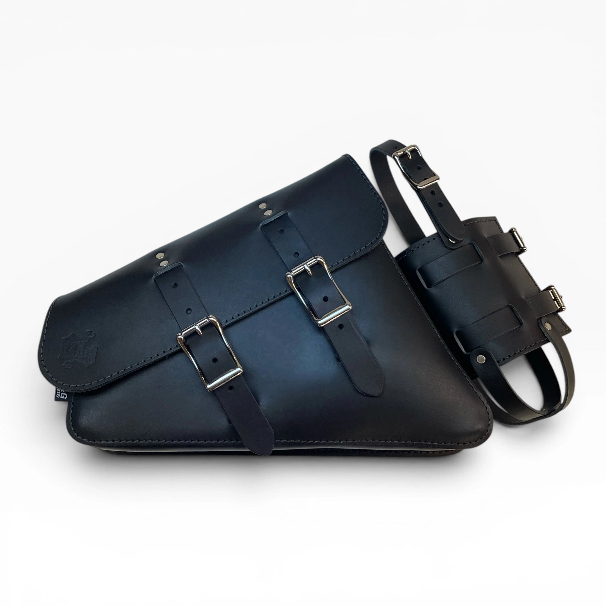 A black leather saddle bag with dual buckle straps, shown alongside a matching black leather belt accessory on a clean white background.