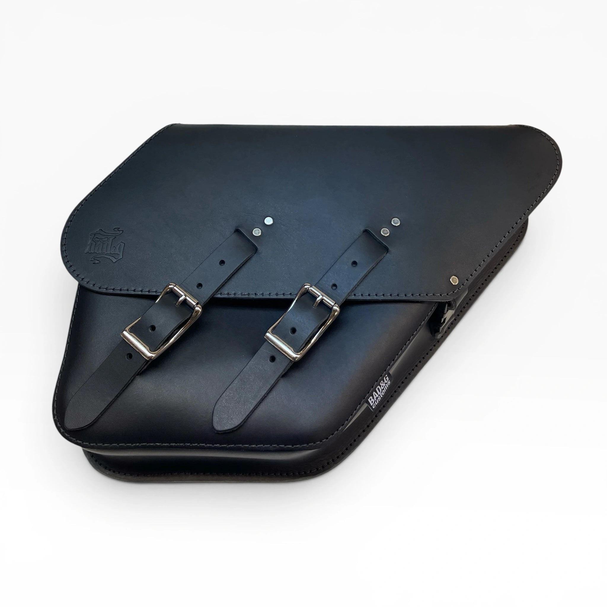 A black leather saddle bag with two adjustable buckle straps and silver metal hardware, photographed on a clean white background.