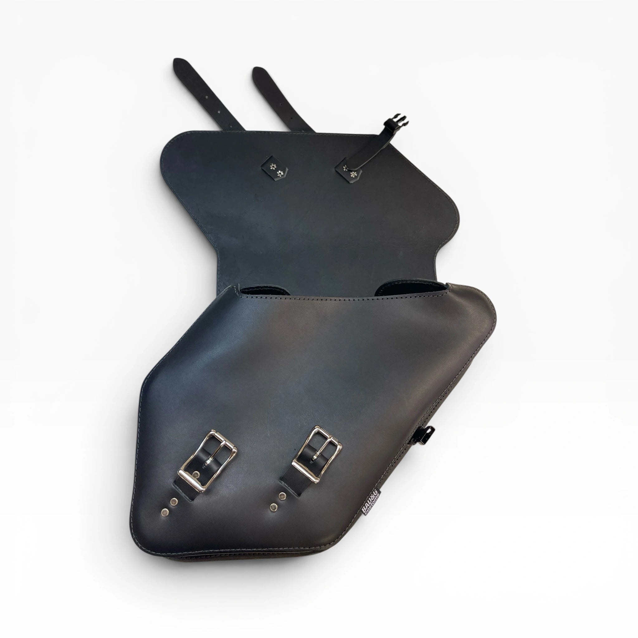 Black leather motorcycle saddlebags shown open against a plain white background, displaying the interior storage compartments and silver buckle hardware.