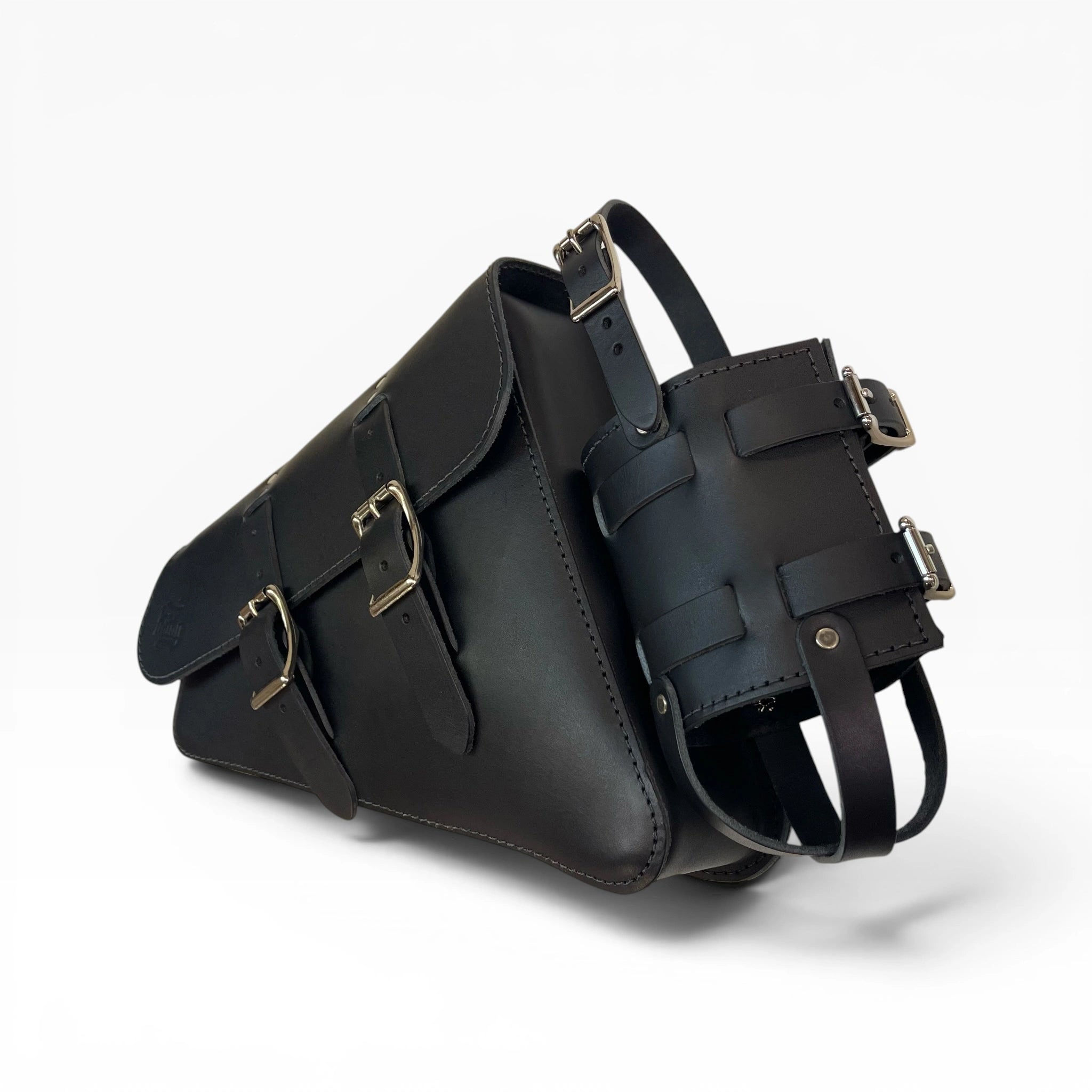 A black leather shoulder bag with multiple adjustable buckle straps and a detachable strap accessory, photographed on a clean white background.